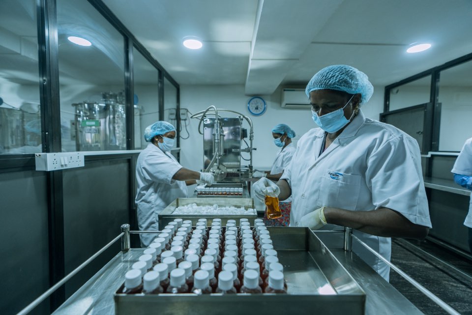 Kelvin Bio Organics filling line in Chennai — operators bottling and capping liquid chemistry